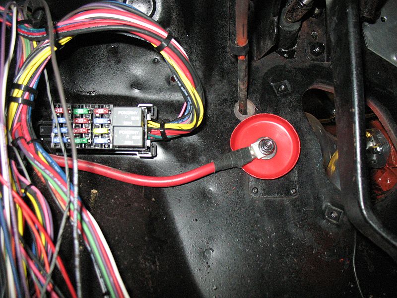Battery cable to the inside under the dash. Two smaller (fused) cables will go on here too.