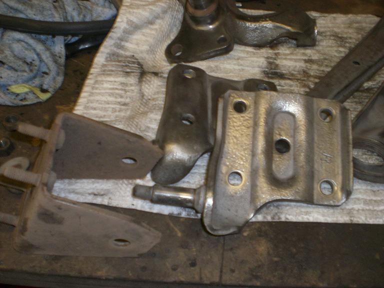 Before and after.Rusty leaf spring bracket to the left