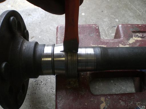 grind a deep slot into retaining coller(don't go too deep and damage the axle) and then use a cheisel and in the slot to crack the collar