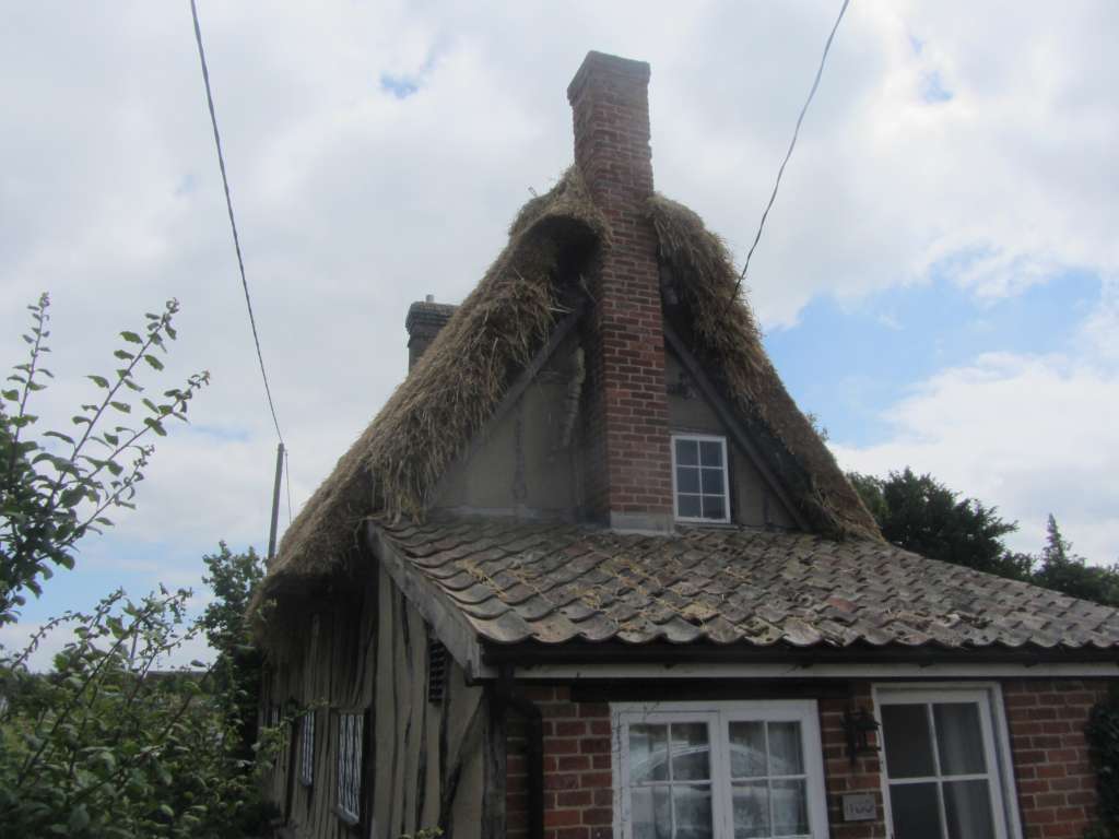 The Thatcher has started on the Front Elevation so that he can then work down the roof on the Ridge. I was surprised at how much material he has had to put on the front......